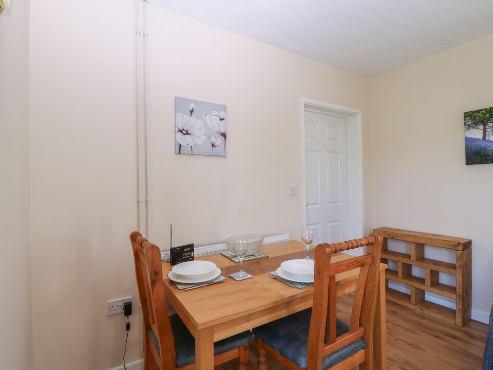 A dining room with a table set for two at The Turbles - Swallows Nest Castlemorton near Welland