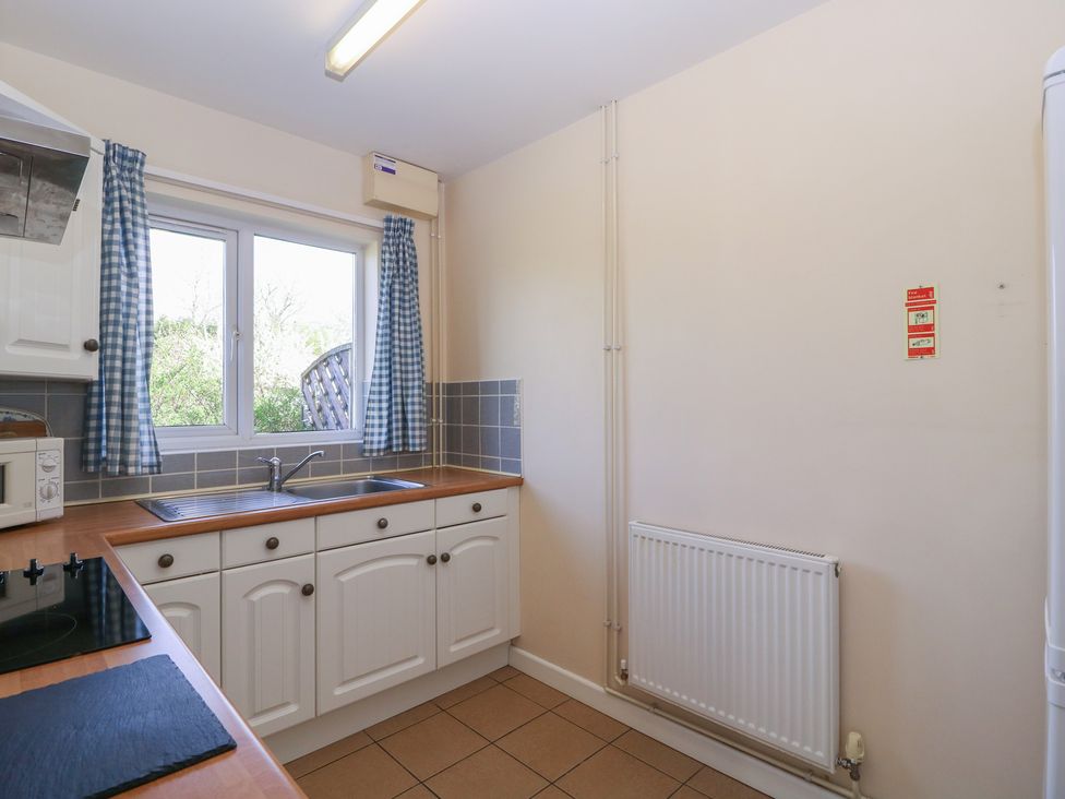 A kitchen with sink and cabinets at The Turbles - Swallows Nest Castlemorton near Welland