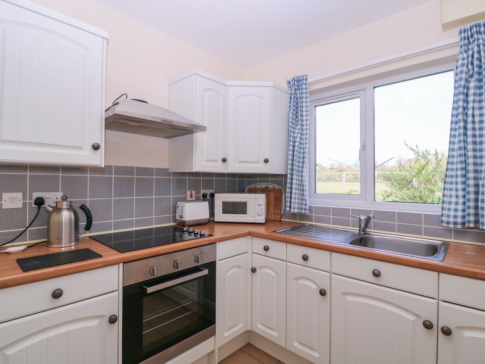 A kitchen with appliances and a window at The Turbles - Swallows Nest near Castlemorton