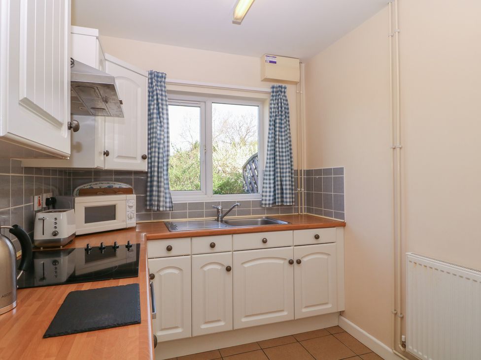 A kitchen with a sink, microwave and stove at The Turbles - Swallows Nest Castlemorton near Welland