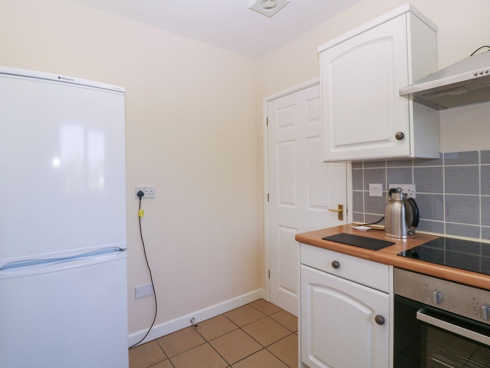 A kitchen with a refrigerator and stove at The Turbles - Swallows Nest Castlemorton near Welland