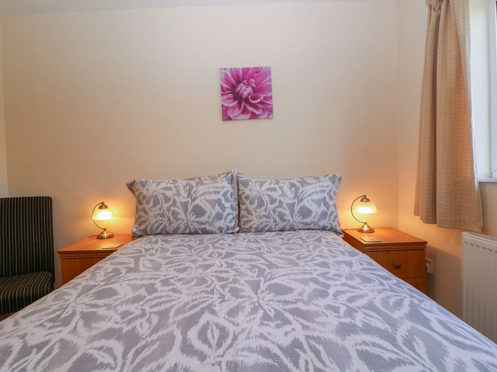 A bedroom with a bed and nightstands at The Turbles - Swallows Nest Castlemorton near Welland
