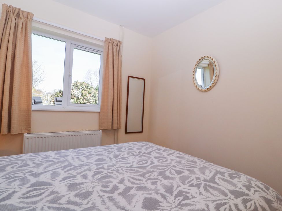 A bedroom with a bed and window at The Turbles - Swallows Nest Castlemorton near Welland