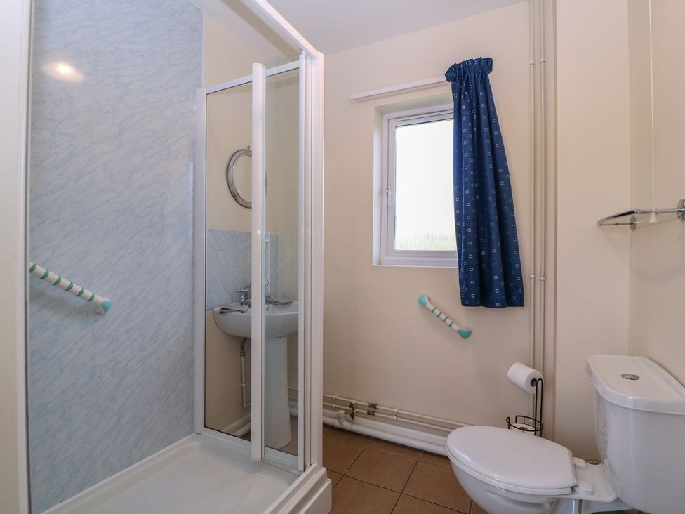A bathroom with shower and washbasin at The Turbles - Swallows Nest in Castlemorton near Welland