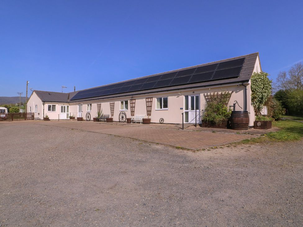 A building with solar panels and gravel driveway at The Turbles - Wagtail Castlemorton near Welland