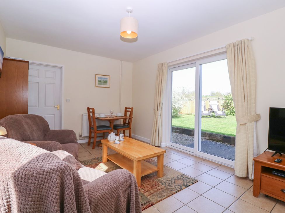 A living room with a dining table and sofa at The Turbles - Wagtail in Castlemorton near Welland