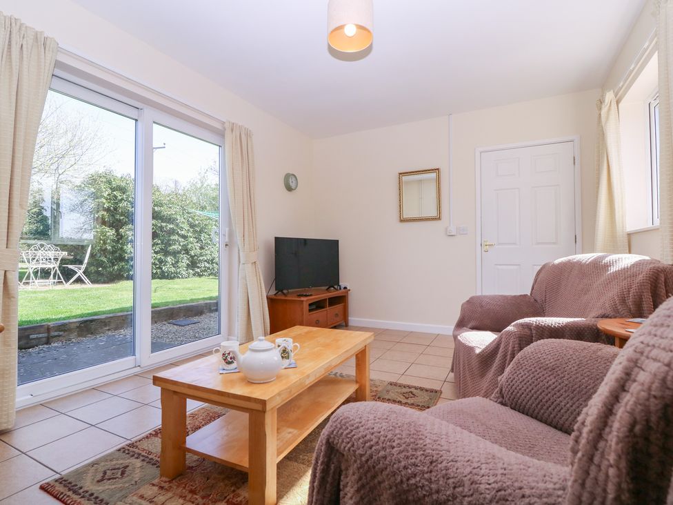 A living room with a sofa and coffee table at The Turbles - Wagtail Castlemorton near Welland
