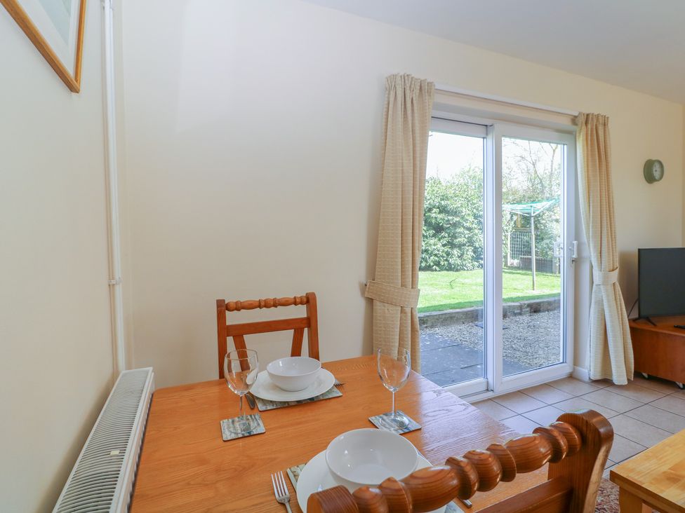 A dining room with a table set for dinner at The Turbles - Wagtail near Castlemorton