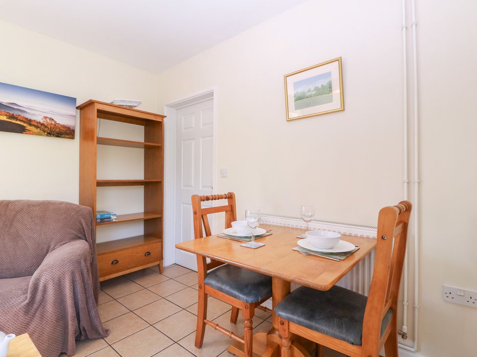 A dining area with a table and chairs at The Turbles - Wagtail in Castlemorton near Welland