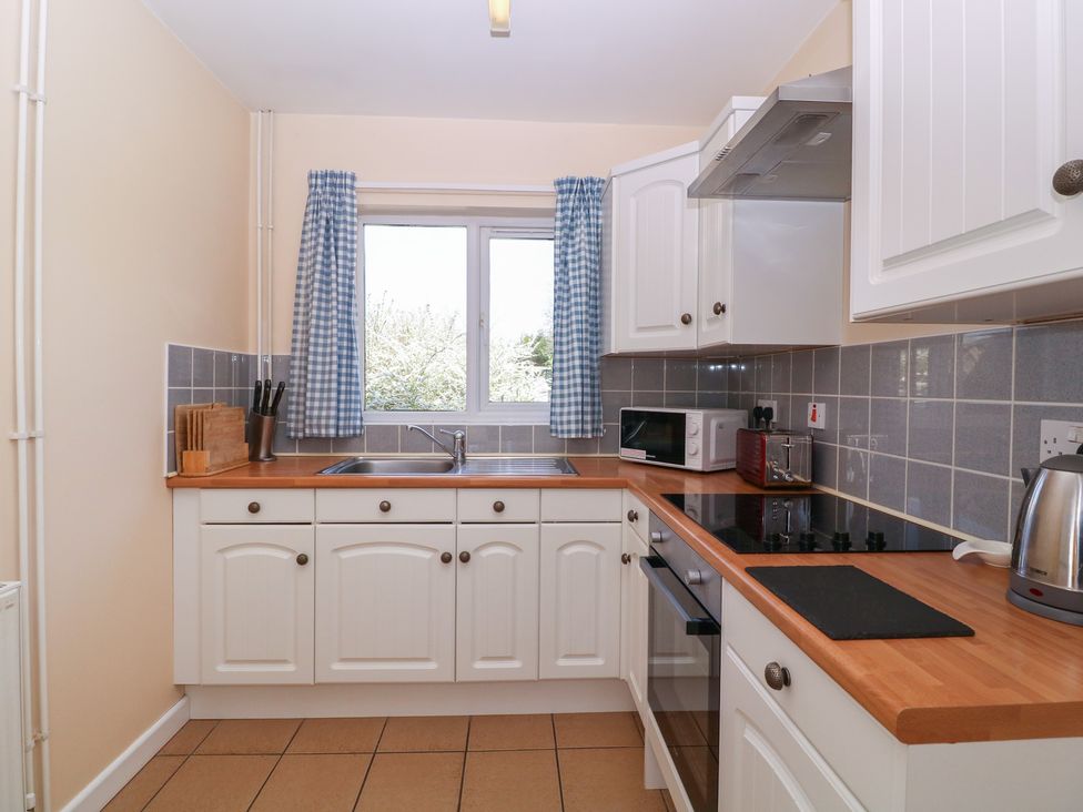A kitchen with a sink and appliances at The Turbles - Wagtail Castlemorton near Welland