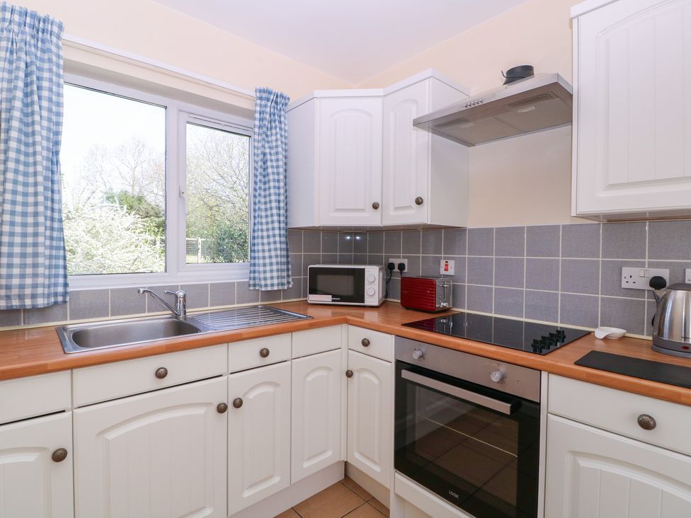 A kitchen with a sink and window at The Turbles - Wagtail in Castlemorton near Welland