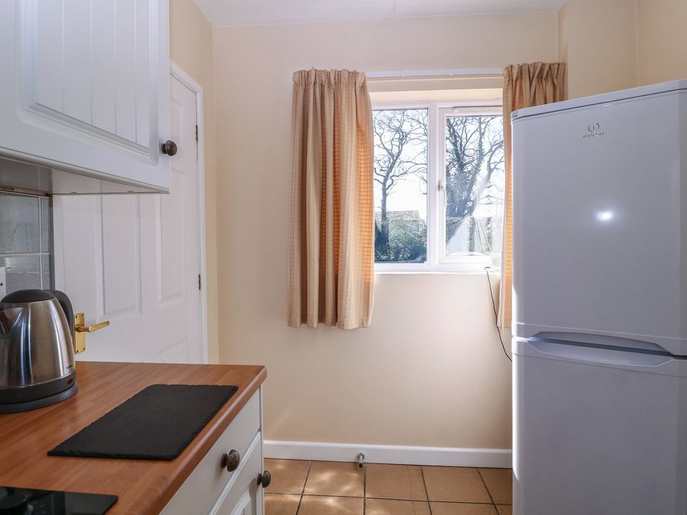 A kitchen with a kettle and refrigerator at The Turbles - Wagtail in Castlemorton near Welland