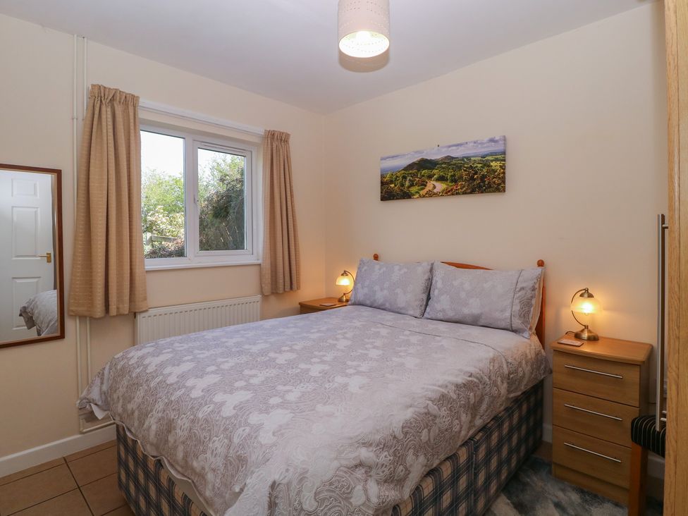A bedroom with a bed and window at The Turbles - Wagtail in Castlemorton near Welland