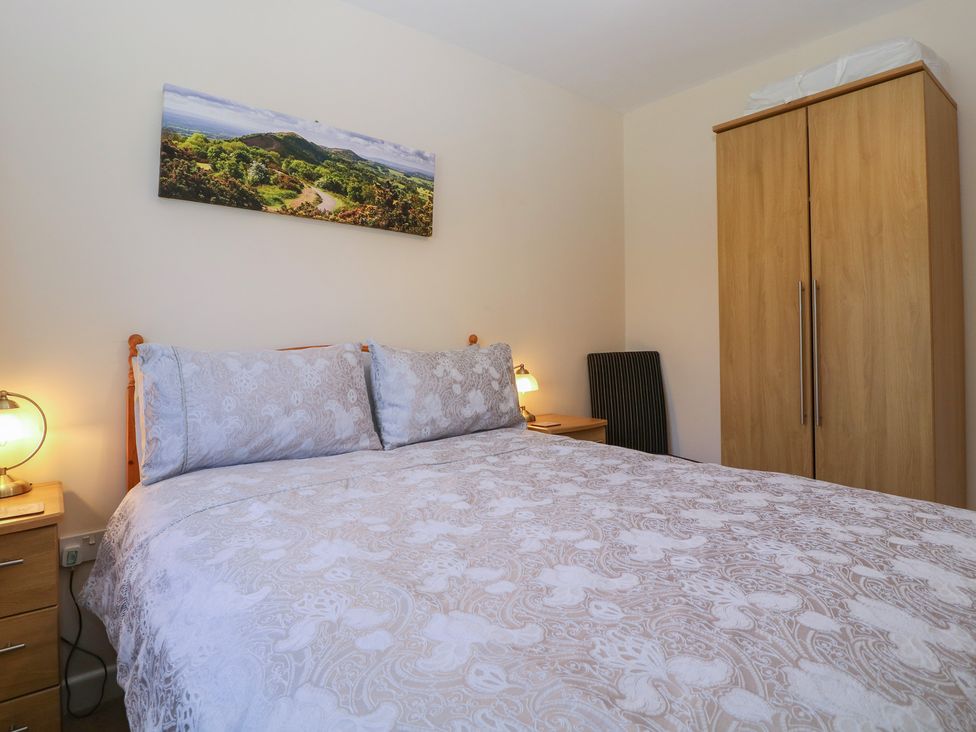 A bedroom with a bed and wardrobe at The Turbles - Wagtail Castlemorton near Welland