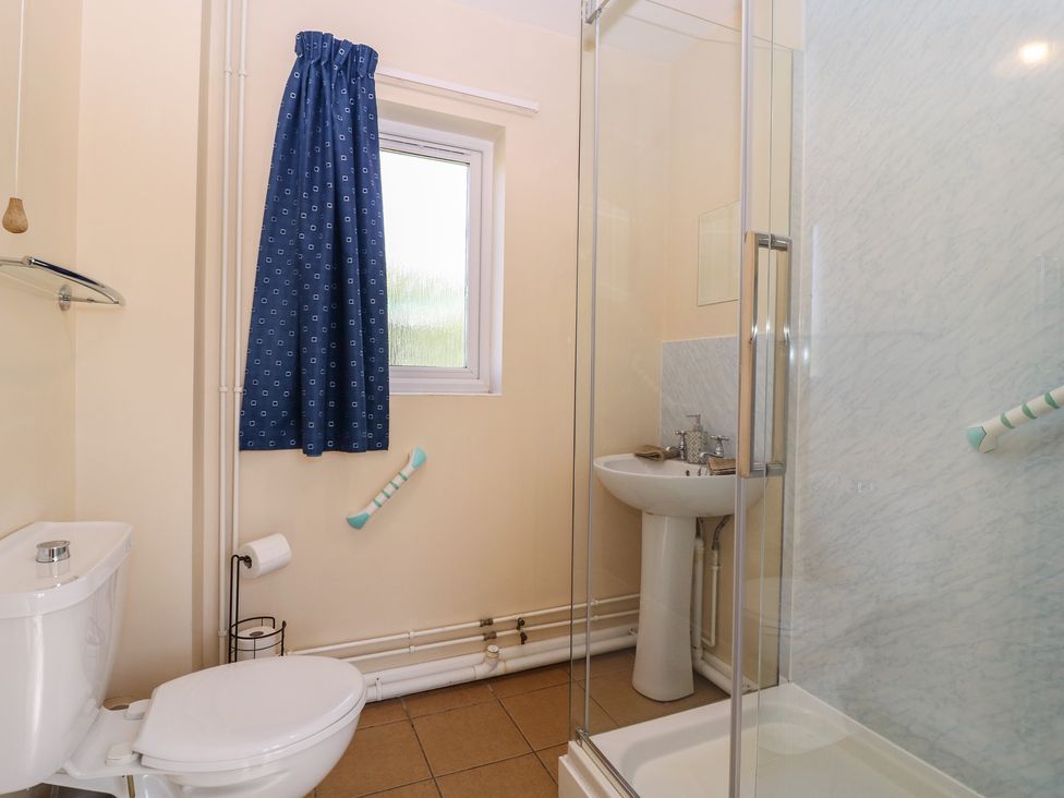 A bathroom with a toilet, sink, and shower at The Turbles - Wagtail in Castlemorton near Welland