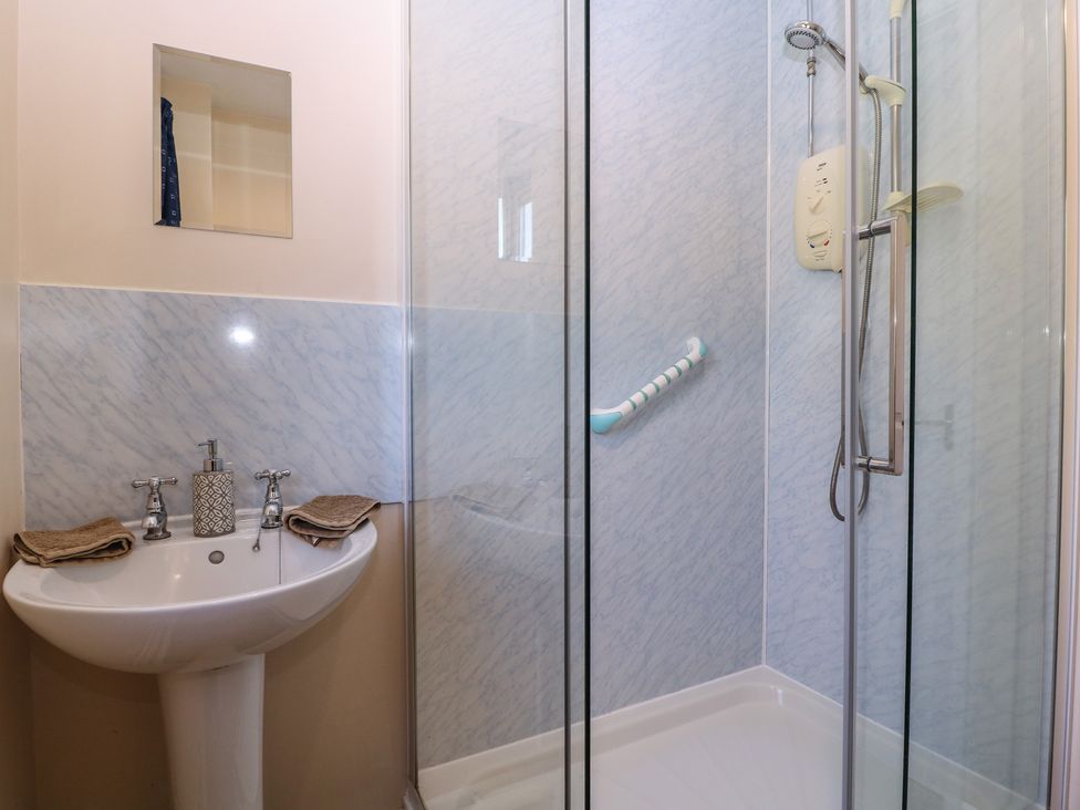 A bathroom featuring a sink, shower and towels at The Turbles - Wagtail in Castlemorton near Welland
