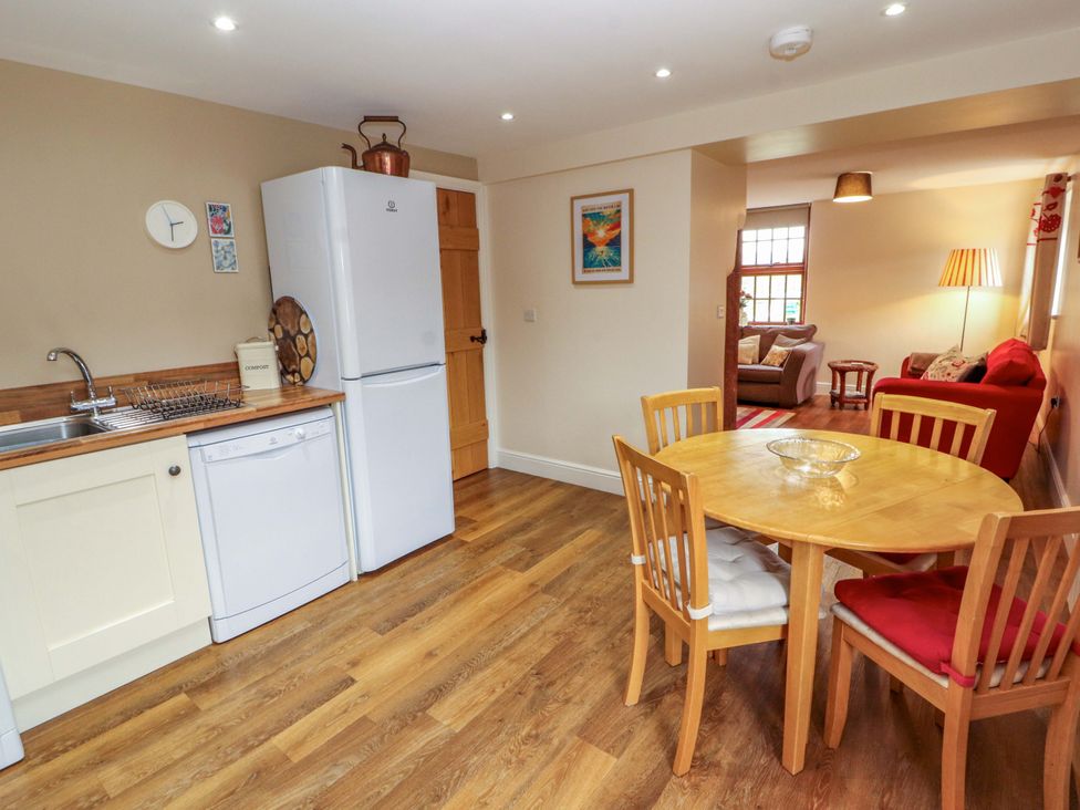 A kitchen with a dining table and chairs at The Old Bothy Bolton Low Houses near Wigton