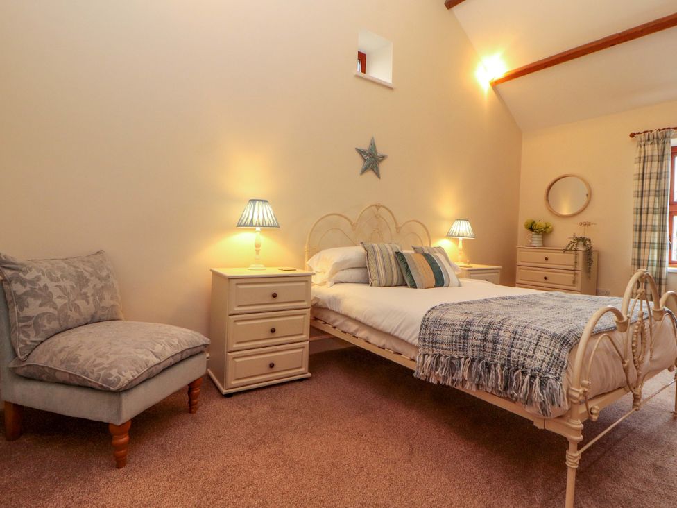 A bedroom with a bed and bedside tables at The Old Bothy Bolton Low Houses near Wigton