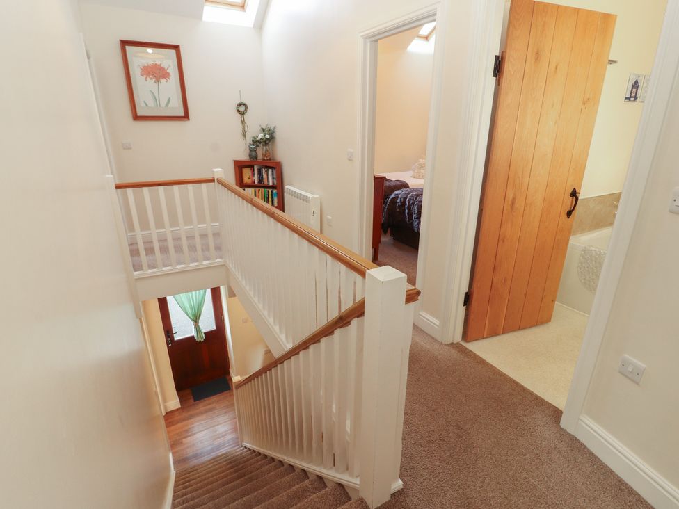 A staircase leading to different rooms at The Old Grainstore Bolton Low Houses near Wigton