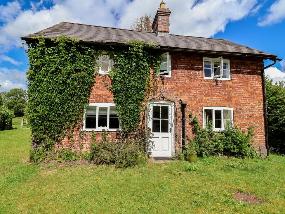 A house with ivy on the exterior at Wolvesacre Mill Cottage Agden near Whitchurch