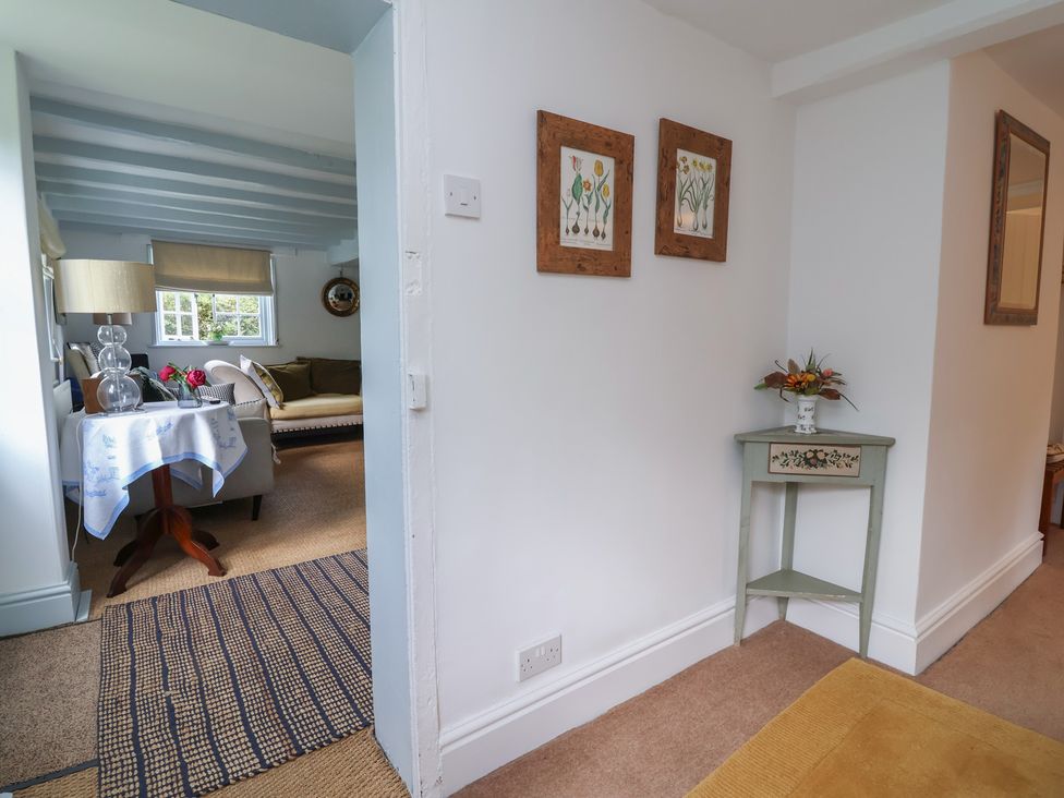 A hallway with a view into a living room at Wolvesacre Mill Cottage in Agden near Whitchurch