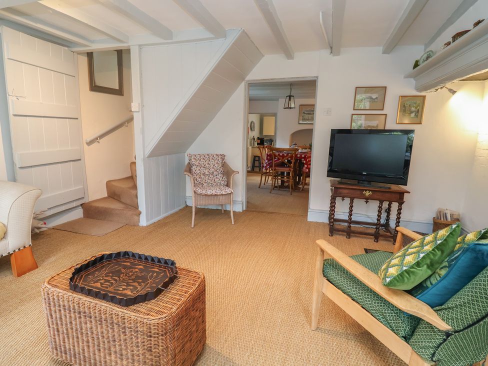 A living room with a television and sofa at Wolvesacre Mill Cottage in Agden near Whitchurch
