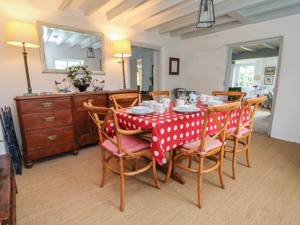 A dining room with a table and chairs at Wolvesacre Mill Cottage Agden near Whitchurch