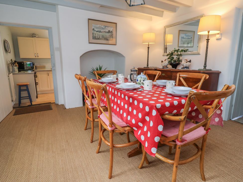 A dining room with a table set at Wolvesacre Mill Cottage in Agden near Whitchurch