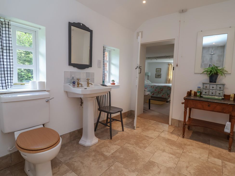 A bathroom with a sink and toilet at Wolvesacre Mill Cottage Agden near Whitchurch