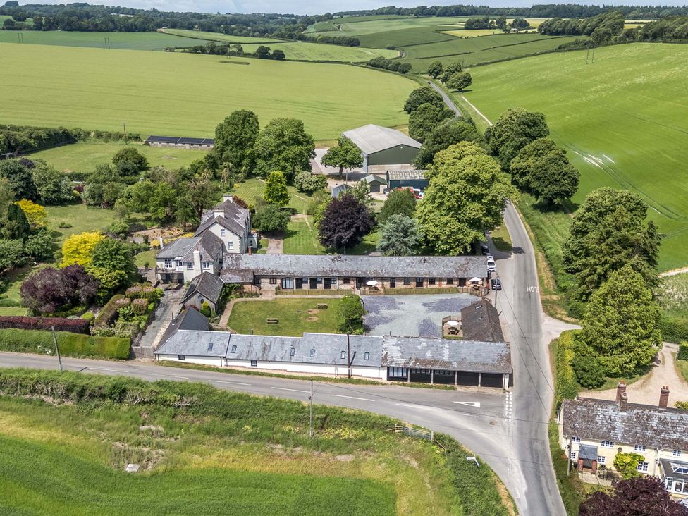 An outdoor area with buildings and fields at The Old Stables Winterborne Stickland