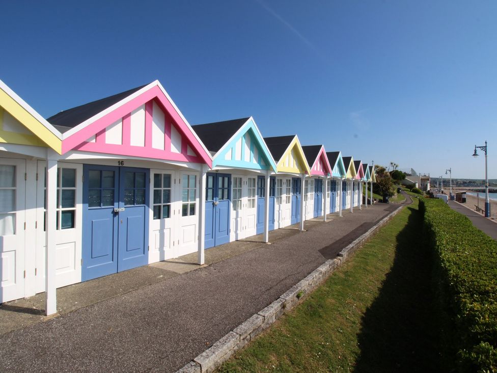 Beach huts along a pathway at The Old Stables Winterborne Stickland