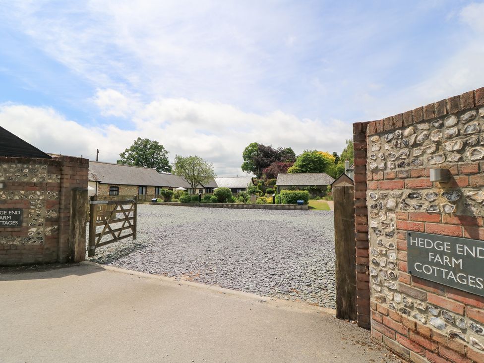 A gravel drive leading to cottages at Hedge End Farm Cottages in Winterborne Stickland