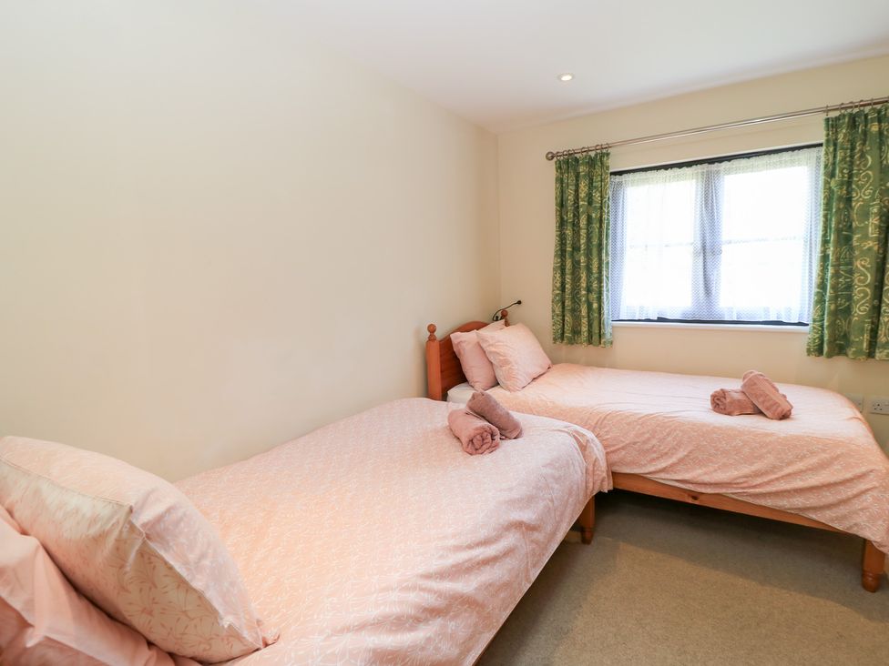 A bedroom with two single beds at Corner Barn in Winterborne Stickland