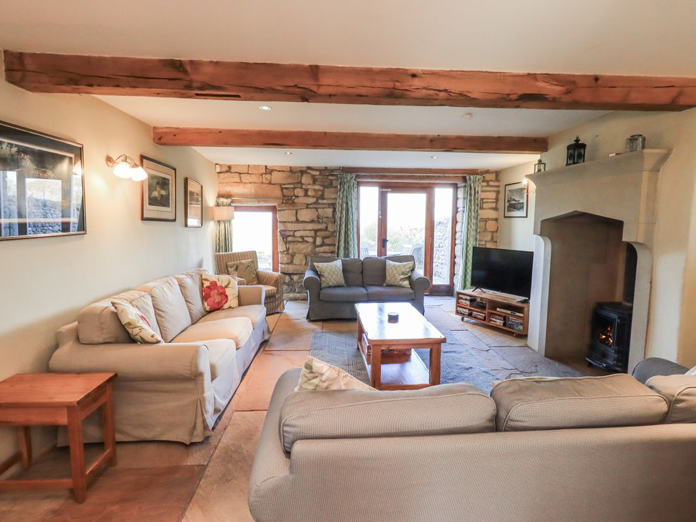 A living room with sofas and a fireplace at Usherwoods Dairy in Tatham