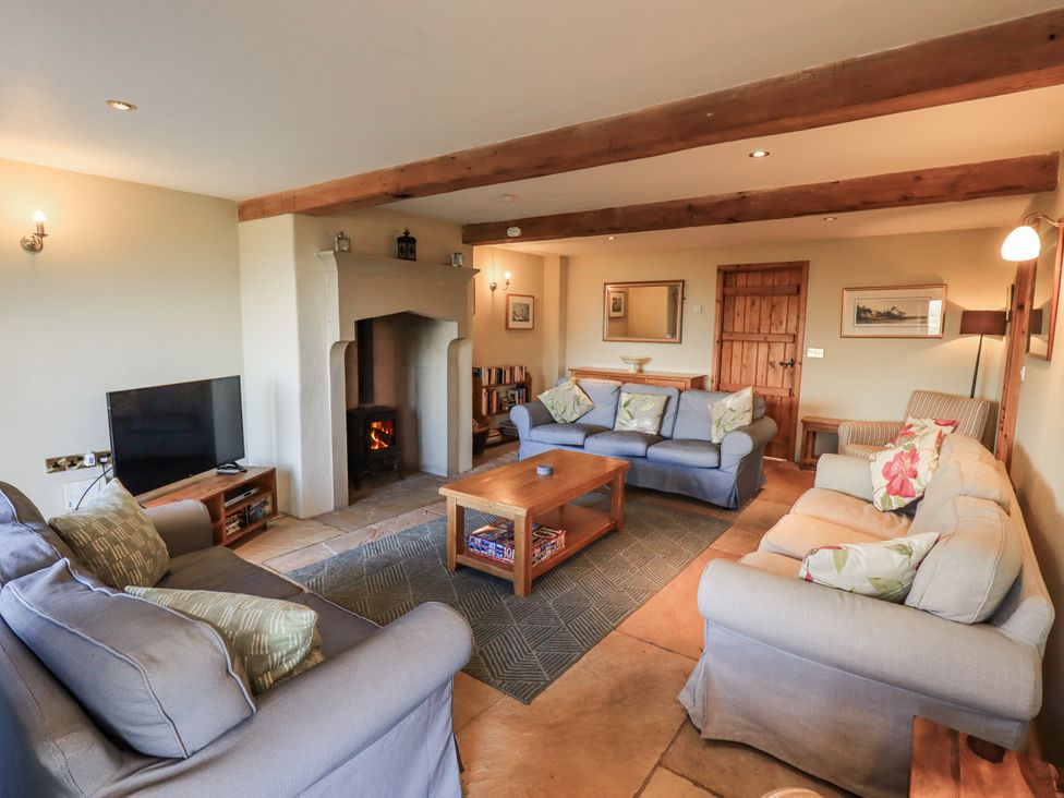 A living room with sofas and a fireplace at Usherwoods Dairy Tatham