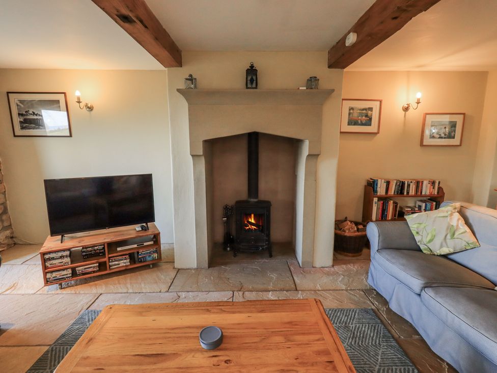 A living room with a television and fireplace at Usherwoods Dairy Tatham