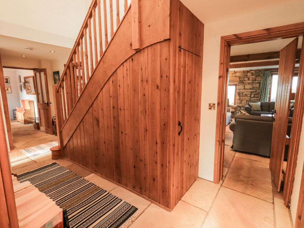 A hallway with a staircase and doorways at Usherwoods Dairy Tatham