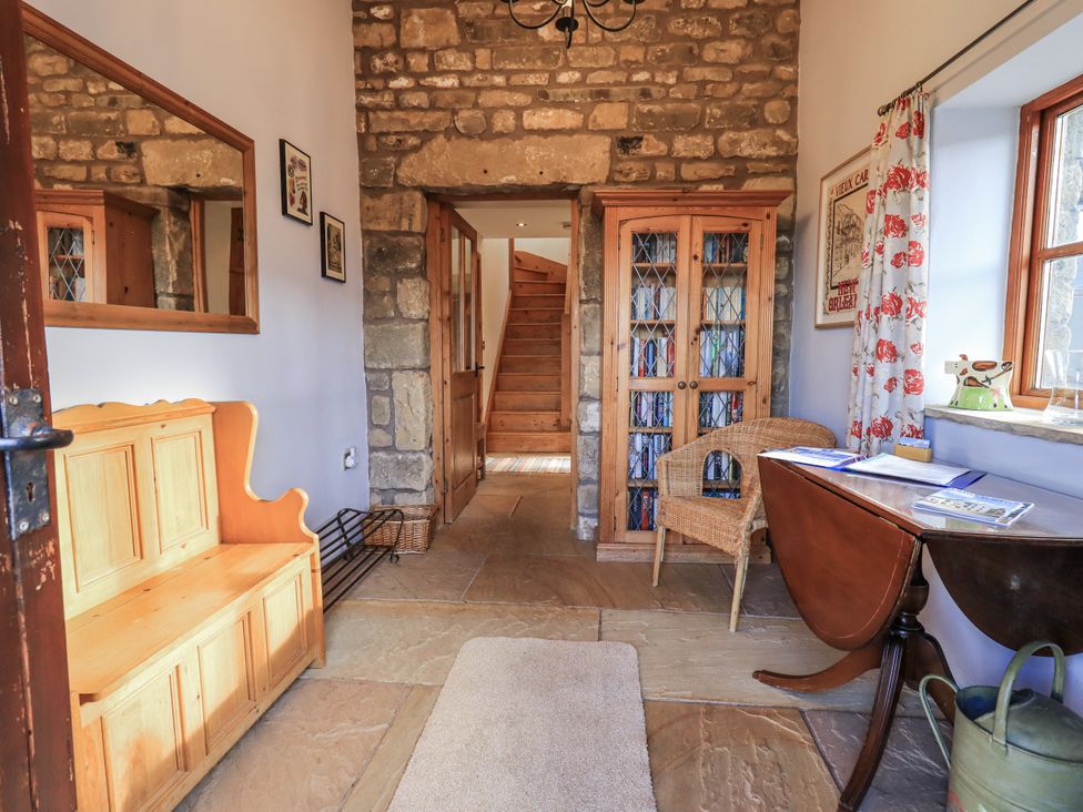 A hallway with a wooden bench and a staircase at Usherwoods Dairy Tatham