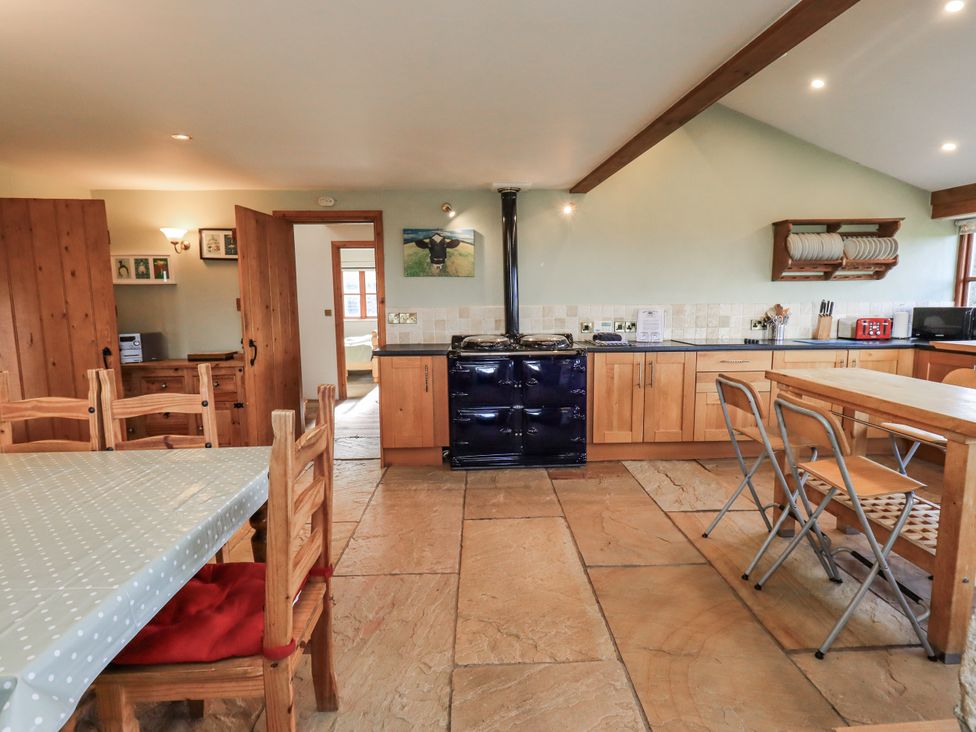 A kitchen with a table and chairs at Usherwoods Dairy Tatham
