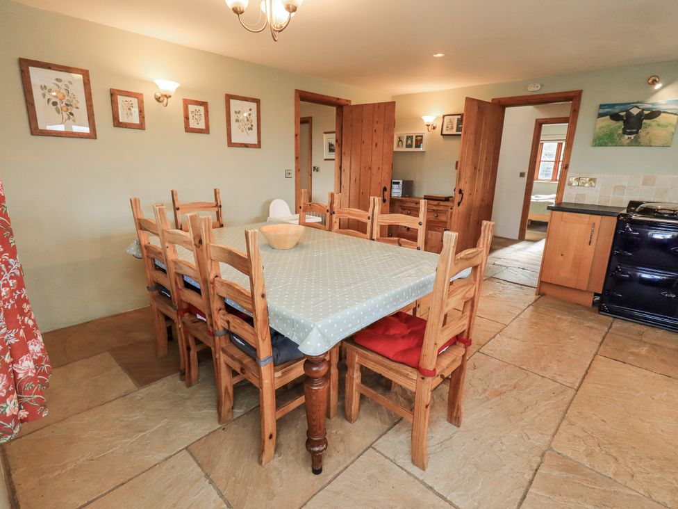A dining room with a table and chairs at Usherwoods Dairy in Tatham