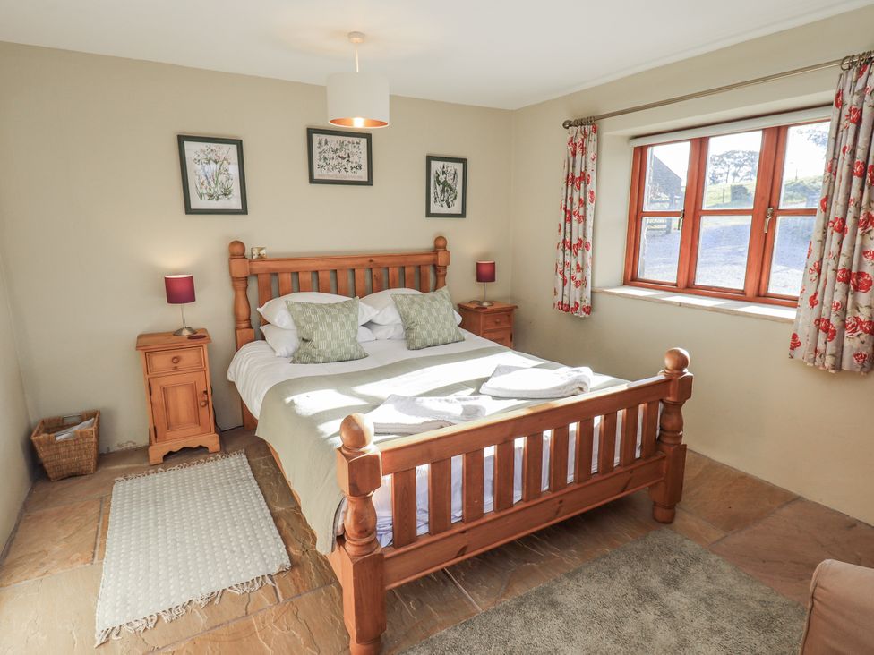 A bedroom with a bed and window at Usherwoods Dairy in Tatham