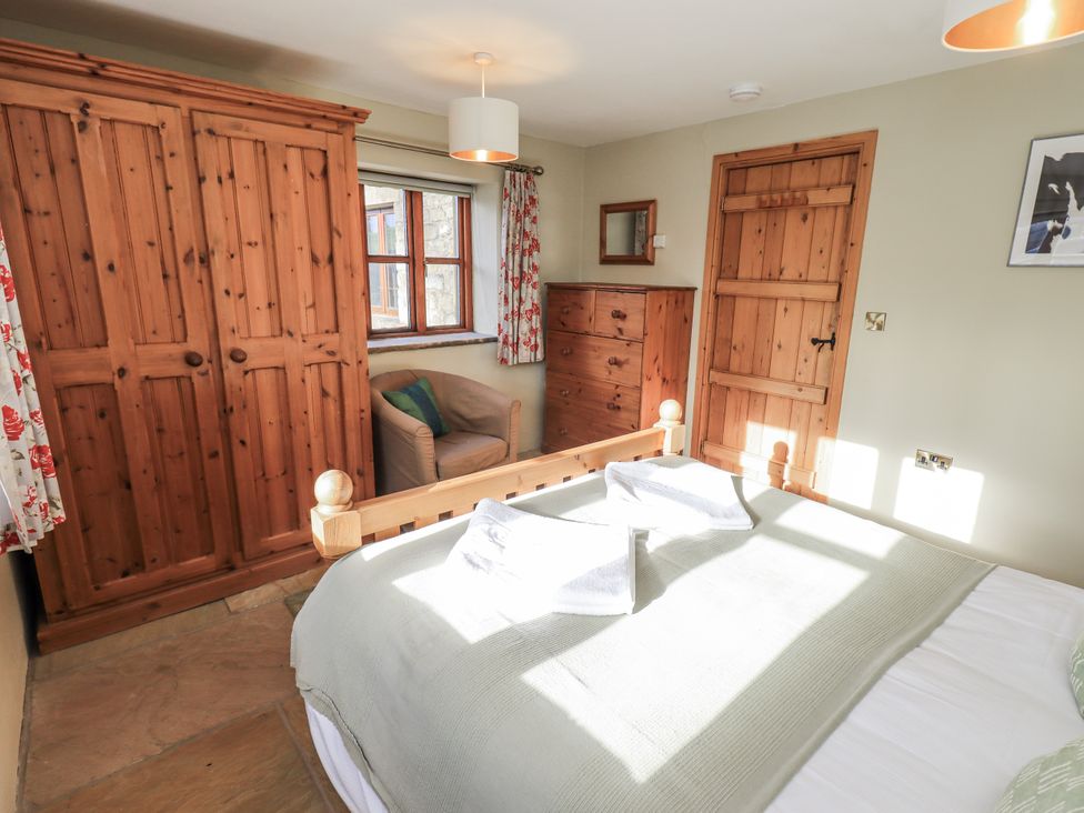 A bedroom with a bed and wardrobe at Usherwoods Dairy in Tatham