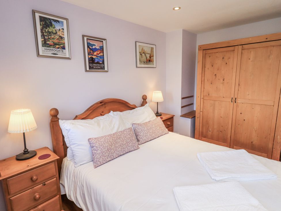 A bedroom with a bed and bedside lamps at Usherwoods Dairy in Tatham