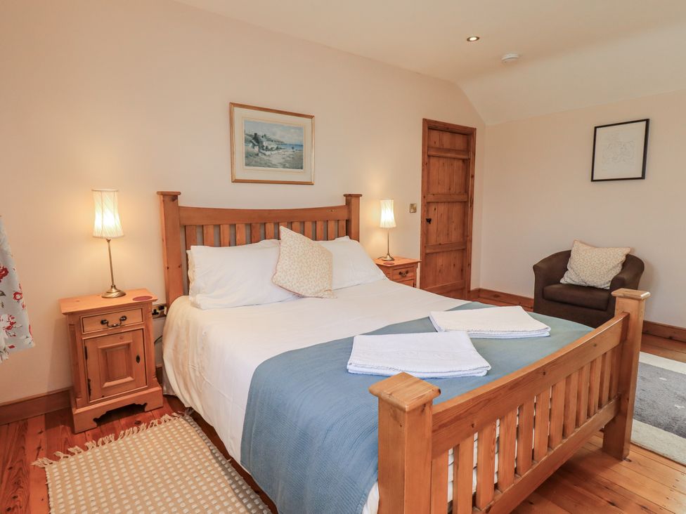 A bedroom with a bed and bedside table at Usherwoods Dairy Tatham