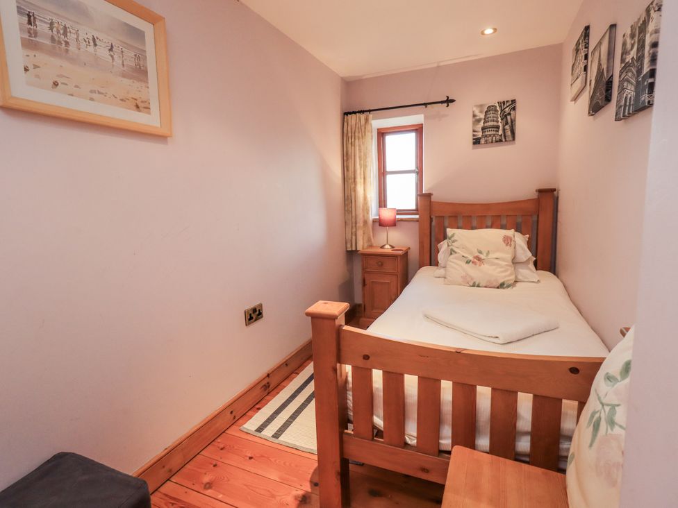 A bedroom with a single bed and bedside table at Usherwoods Dairy in Tatham