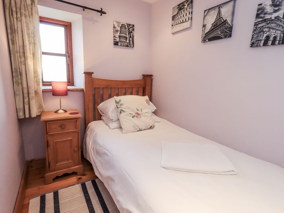A bedroom with a bed and bedside table at Usherwoods Dairy, Tatham