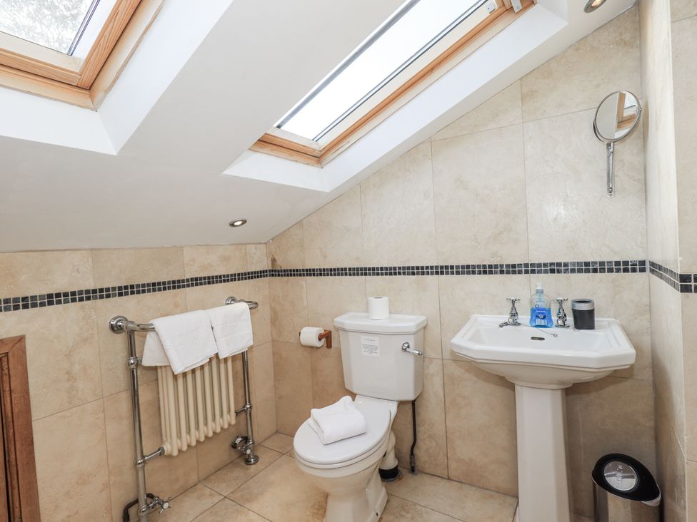 A bathroom with toilet, sink, and towel radiator at Usherwoods Dairy Tatham