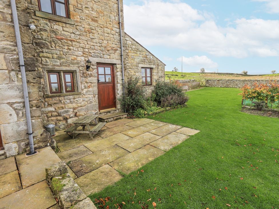 A patio area with stone features and a garden at Usherwoods Dairy Tatham