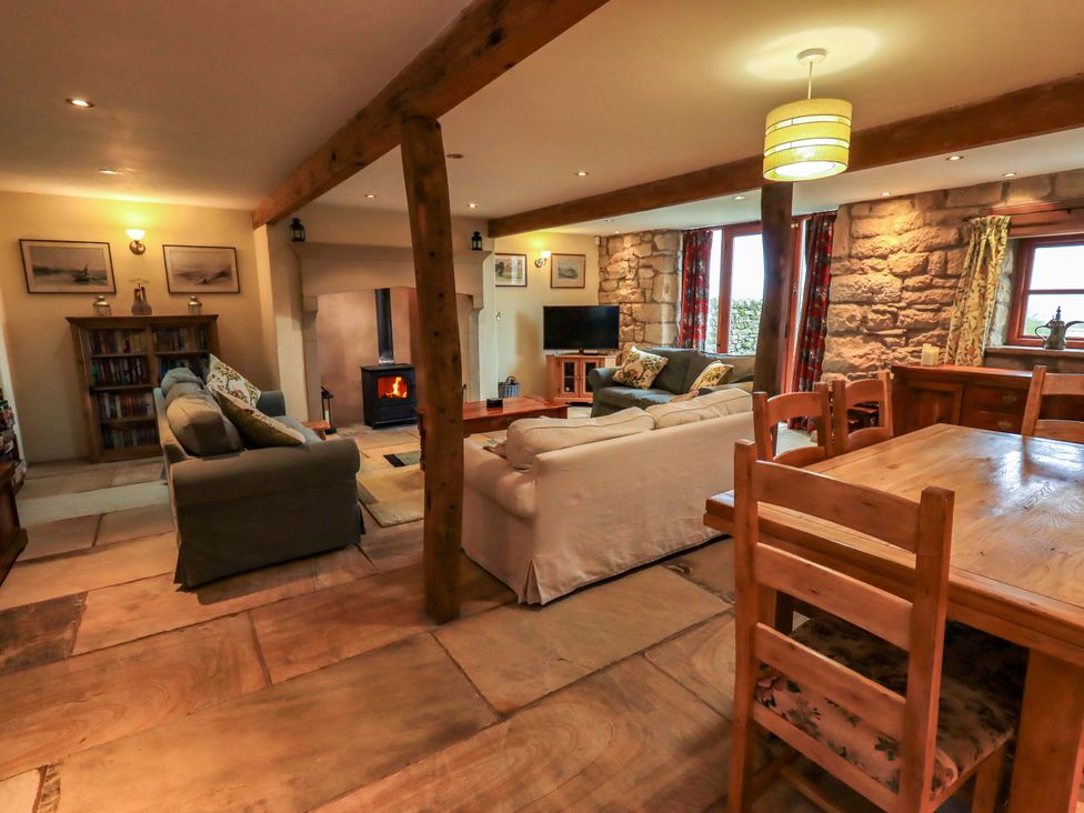 A living room with seating and dining area at Usherwoods Barn Tatham