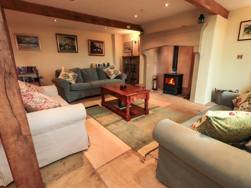 A living room with a fireplace and sofa at Usherwoods Barn in Tatham